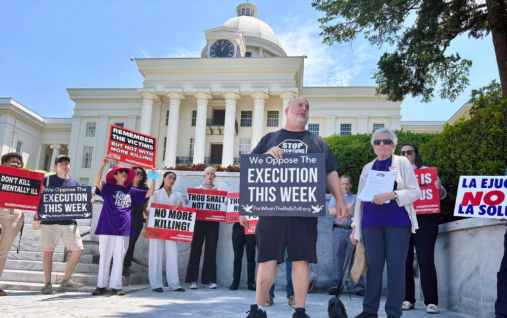 Abraham Bonowitz of Death Penalty Action and Esther Brown of Project Hope to Abolish the Death Penalty in Alabama stand with other death penalty opponents at a Tuesday, July 16, 2024, rally in front of the Alabama Capitol in Montgomery, Ala. (AP Photo/Kim Chandler)